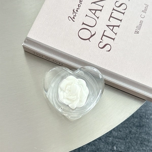 Macro view of transparent heart phone socket with a 3D white rose flower model
