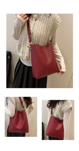 Detail of red leather bucket bag with gold adjustment buckle and natural pleated closure