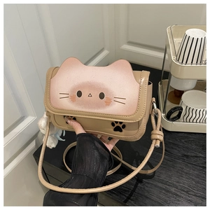 Detail of cartoon cat crossbody bag in khaki and pink PU leather with plush charm