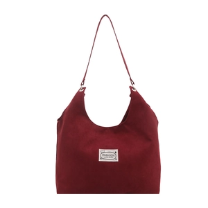 Minimalist burgundy suede tote bag with stylish logo patch and silver metal eyelet straps