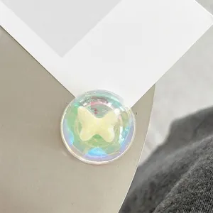 Detail of a transparent iridescent phone socket with a 3D butterfly design