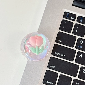 Macro detail of clear resin phone socket with pink tulip and aurora glitter finish