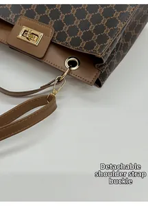 Close-up of the detachable shoulder strap buckle and gold hardware on retro tote