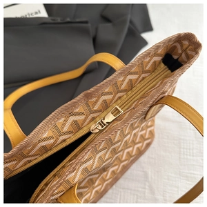 Detailed top view of a geometric print tote bag featuring high-quality zipper and yellow handles