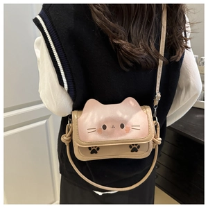 Detail of cute cat-shaped crossbody bag featuring 3D ears and paw print patterns