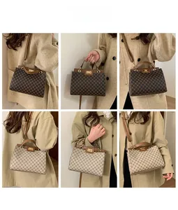 Detail view of large-capacity vintage crossbody bag with gold lock and floral pattern