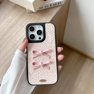 Detail of pink snakeskin iPhone case with silk bows and Love is forever metal tag