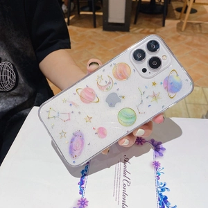 Detail of transparent iPhone case featuring glittery stars and colorful planet patterns