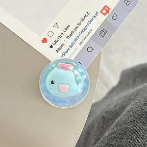 Detailed view of 3D blue whale phone socket grip on a decorative background card