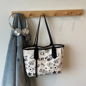 Large capacity tote bag with black cartoon graffiti prints and leather shoulder straps