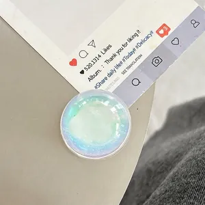 Close-up of iridescent glitter phone socket with white cloud motif and opal finish