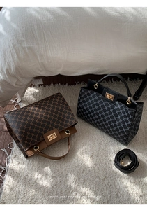Detail of vintage monogram tote bags in brown and black with gold turn-lock closure