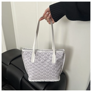 Detail of printed tote bag with waterproof coated canvas and white leather handles