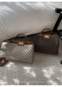 Macro detail of retro patterned handbags with gold lock and textured leather finish