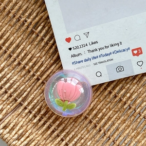 Close-up of iridescent resin phone grip featuring an 3D pink tulip and green stem inlay