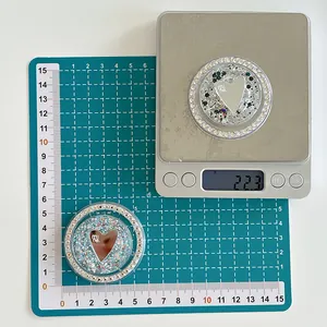 Close-up of glitter heart phone grip with rhinestones on scale showing 22.3g weight