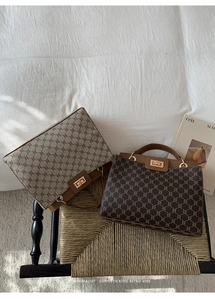 Detail of vintage monogram handbags in beige and dark brown with gold metal twist locks
