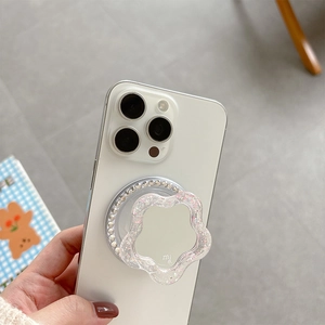 Detailed view of flower-shaped magnetic phone grip with rhinestones and built-in mirror