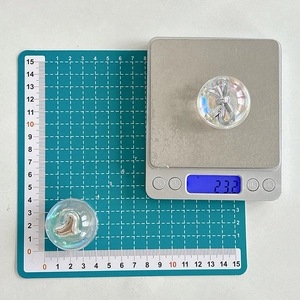 Close-up of 3D bow and heart crystal bubble grips for phones on a precise digital scale