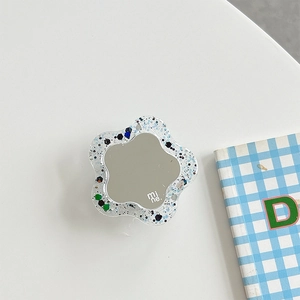 Detail of flower phone grip featuring glitter sequins and a mirror with mine text