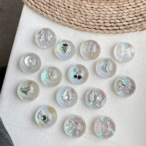 Iridescent crystal phone grips with silver bow and heart motifs on a textured base