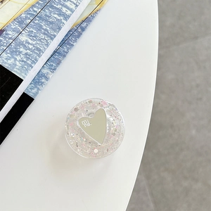 Detail of a round phone socket with heart mirror and colorful glitter sequins