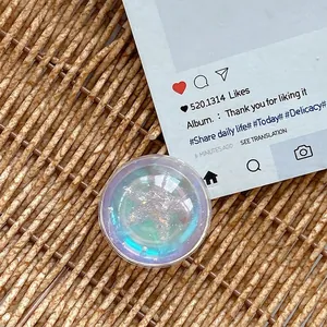 Macro detail of round heart crystal ball phone grip with iridescent glitter and foil