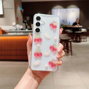Clear Samsung Galaxy S25 case with 3D pink cherries, pearls and cute ribbon bow