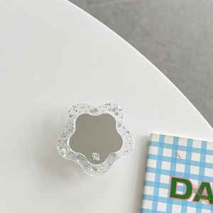 Detail view of flower-shaped phone grip with glitter resin and mirror surface