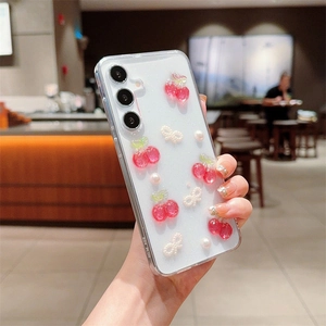 Detail of S24 Plus case with 3D resin cherries, pearls, bows, and fine glitter finish