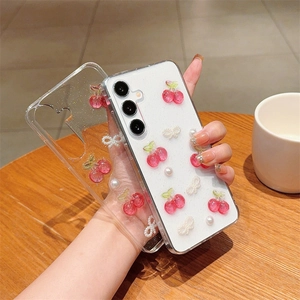 Detail of transparent phone case with resin cherries, bows and pearls for Samsung Galaxy