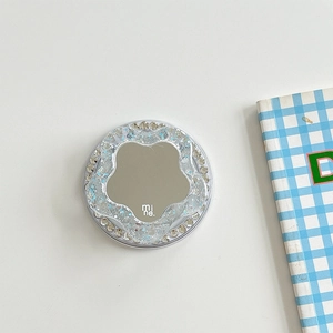 Macro detail of magnetic phone socket with floral mirror, rhinestones and blue glitter
