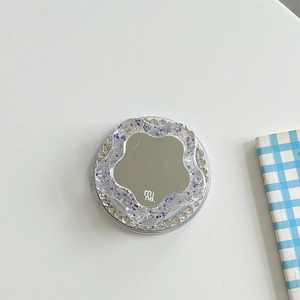Macro detail of rhinestone phone socket with floral mirror and sparkling glitter finish