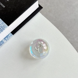 Macro view of iridescent crystal phone grip with embedded silver metallic rose detail