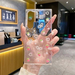 Close-up of clear phone case with 3D resin strawberries and pearl bows decorations