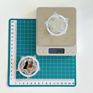Gros plan du support MagSafe en étoile avec paillettes et miroir sur une balance
