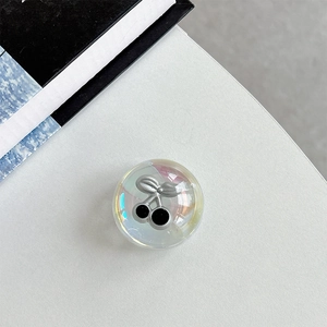Close-up of a dreamy iridescent crystal ball phone grip with 3D silver cherry design