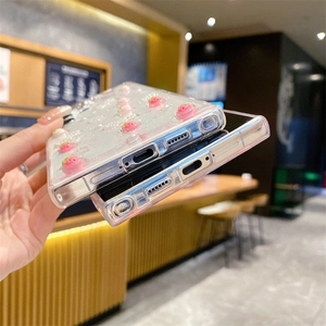 Close-up of precise cutouts and glitter strawberry patterns on clear phone cases