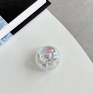 Macro view of iridescent resin phone grip with metallic silver bow detail for girls