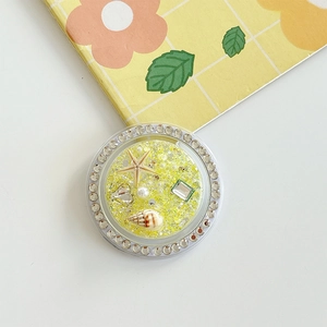 Detail of starfish and shell grip tok with yellow glitter and rhinestones