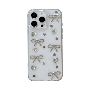 Custodia iPhone glitterata con fiocchi di strass 3D, cuori e cristalli su base trasparente