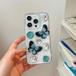 Detail of 3D blue butterflies and rhinestones on white glitter iPhone case