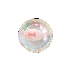 Iridescent crystal ball phone grip with pink candy and bow tie center on white background