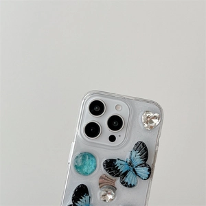 Close-up of transparent iPhone case with 3D blue butterfly and crystal stone decor