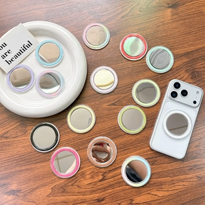 Colorful MagSafe magnetic phone mirror grips in various pastel colors on a wooden table