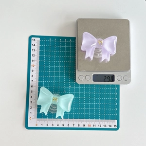 Detail of cute solid color bow phone sockets showing dimensions and 29.8g weight