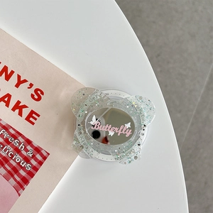 Detail of glitter butterfly phone grip mirror with pink Butterfly lettering and shiny sequins
