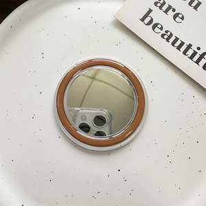 Detailed close-up of a circular MagSafe vanity mirror with brown and clear double-layer frame