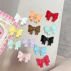 Colorful resin bow phone grip stands in eleven vibrant shades with gold detailing