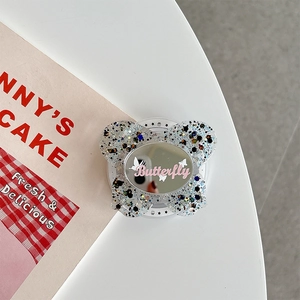 Detail view of butterfly phone grip with colorful sequins and integrated makeup mirror